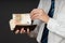 Businessman putting banknotes in his wallet. Stack of fifty euros money. Business man is holding cash. Person pays in euro bills