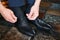 Businessman putting on black leather shoes for work.