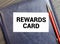 Businessman putting a card with text REWARD PERFORMANCE in the pocket