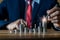 Businessman putting down money, pointing with pen and showing candlestick symbol for investing, finance