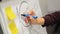 Businessman putting his ideas on white board during a presentation in conference room. Focus in hands with marker pen