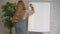 Businessman putting his ideas on white board during a presentation in conference room. Focus in hands with marker pen