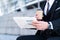 Businessman reading finance news in newspaper with coffee