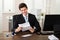 Businessman Reading Paper In Office