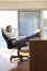 Businessman Reclining With Feet Up On Desk