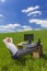 Businessman Relaxing Feet Up Desk in Green Field