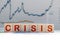 Businessman removes wooden blocks with the word Crisis. The exit from the crisis and financial stability. Focus on resolving the