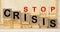 Businessman removes wooden blocks with the word Crisis. The exit from the crisis and financial stability. Focus on resolving the