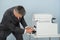 Businessman Removing Paper Stuck In Printer At Office