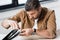 Businessman repairing damaged laptop while sitting