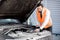 Businessman repairing his car on the road