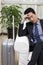 Businessman resting head on pile of boot