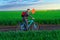 businessman rides a bicycle through a green grass field, the concept of activity, leisure or freelancing
