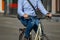 Businessman rides to work on a bicycle. Elegantly dressed man riding a bicycle in town