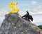 Businessman riding bear pursuing gold dollar sign on mountain pe