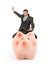 Businessman riding pigy bank