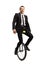 Businessman riding a unicycle and smiling at the camera