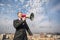 Businessman on the roof with megaphone