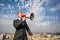 Businessman on the roof with megaphone