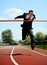 Businessman running on athletic track celebrating victory in work success concept