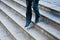 Businessman running down city stairs