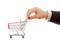 Businessman\'s hand pushes shopping cart