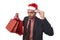 Businessman in Santa Claus Christmas hat holding sopping bags and credit card in worried and stress