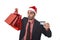 Businessman in Santa Claus Christmas hat holding sopping bags and credit card in worried and stress