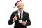 Businessman with a Santa Claus hat holding a cup of espresso coffee and showing thumbs up