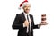 Businessman with a Santa Claus hat holding a plate with chocolate donuts and pointing