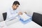 Businessman searching documents at desk in office