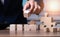 The businessman setting up a wooden cube with space for writing letters to plan the work, business concept.