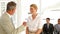 Businessman shaking the hand of job applicant and talking with her