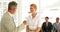 Businessman shaking the hand of job applicant and talking with her