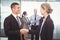 Businessman shaking hands with businesswoman