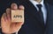 Businessman showing APPS word in wooden cube.