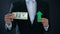 Businessman showing dollar banknote and green arrow sign, exchange rate growing