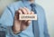 Businessman showing Leverage word in wooden block.