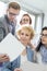 Businessman showing photograph to colleagues in creative focus