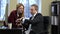 A businessman shows an attractive young woman smart watch at the office.