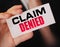 Businessman shows a card with text Claim Denied . Injury claim insurance concept