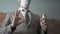 Businessman shows ok gesture holding a sanitizer or antiseptic liquid. Close up shot. Positive man in a protective mask