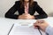 Businessman sign contract with businesswoman sitting at desk