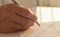 Businessman is signing a contract, close up of male hand putting signature