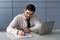 Businessman signs documents do paperwork seated at workplace