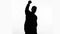 Businessman silhouette raises fist up, celebrates success, proud of achievement