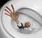 Businessman sinking in toilet bowl