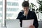 Businessman sit at desk holding paper reading letter feels frustrated