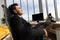 Businessman sits, lean his legs on table and nap