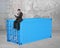 Businessman sitting on 3d blue cargo container